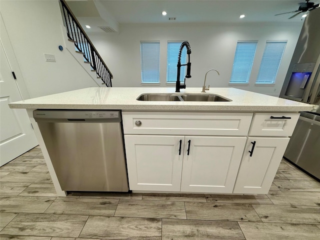 6635 Tc Jester Blvd Unit A, Houston, TX 77007 - kitchen featuring dishwasher, wood finish floors, white cabinets, light stone counters, and recessed lighting