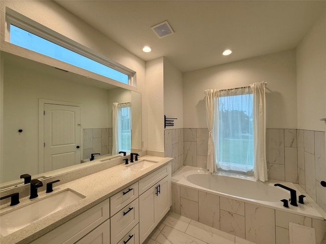 6635 Tc Jester Blvd Unit A, Houston, TX 77007 - bathroom featuring marble finish flooring, a garden tub, double vanity, plenty of natural light, and recessed lighting