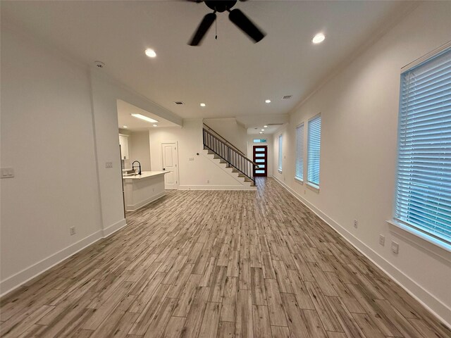 6635 Tc Jester Blvd Unit A, Houston, TX 77007 - unfurnished living room with light wood-type flooring, ceiling fan, stairway, and recessed lighting