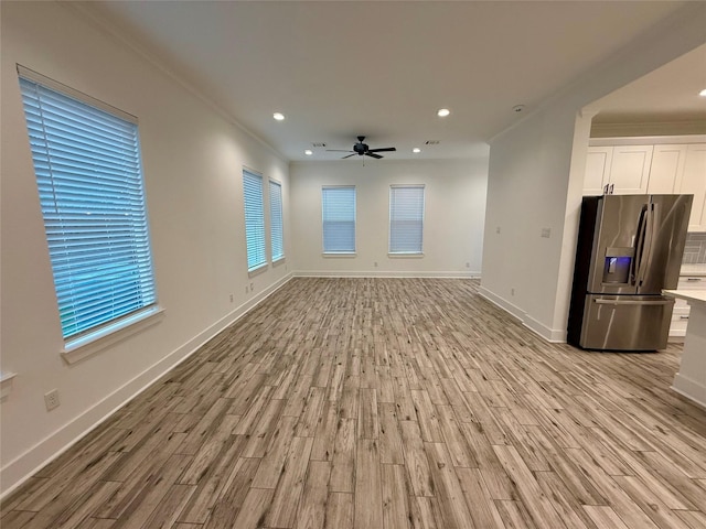6635 Tc Jester Blvd Unit A, Houston, TX 77007 - unfurnished living room featuring light wood finished floors, ceiling fan, crown molding, and recessed lighting