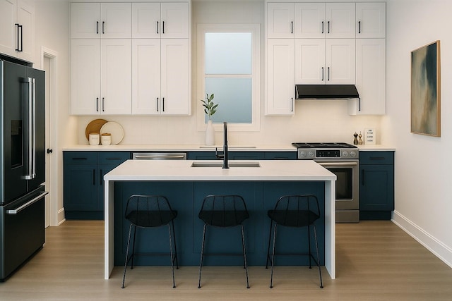 811 Thornton Rd Unit B, Houston, TX 77018 - kitchen with stainless steel appliances, under cabinet range hood, light wood-style flooring, and a breakfast bar