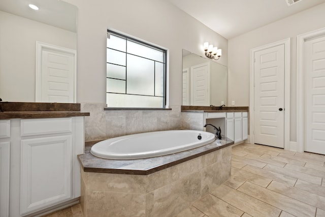 16715 Bark Cabin Dr, Humble, TX 77346 - bathroom featuring vanity, a garden tub, and tile patterned floors