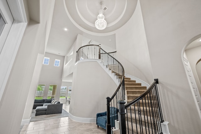 16715 Bark Cabin Dr, Humble, TX 77346 - stairway with a high ceiling, wood finished floors, arched walkways, and recessed lighting