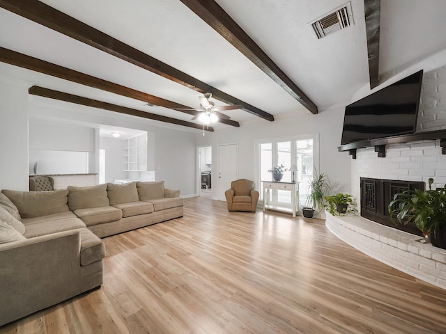 19518 Barwick Dr, Spring, TX 77373 - living area with a fireplace, beam ceiling, ceiling fan, and light wood finished floors