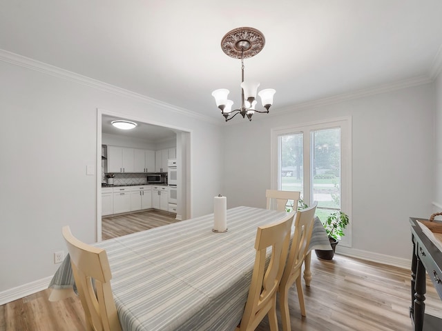19518 Barwick Dr, Spring, TX 77373 - dining area featuring a chandelier, light wood-style floors, and ornamental molding