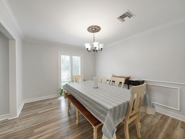 19518 Barwick Dr, Spring, TX 77373 - dining area with a chandelier, crown molding, and light wood-style flooring