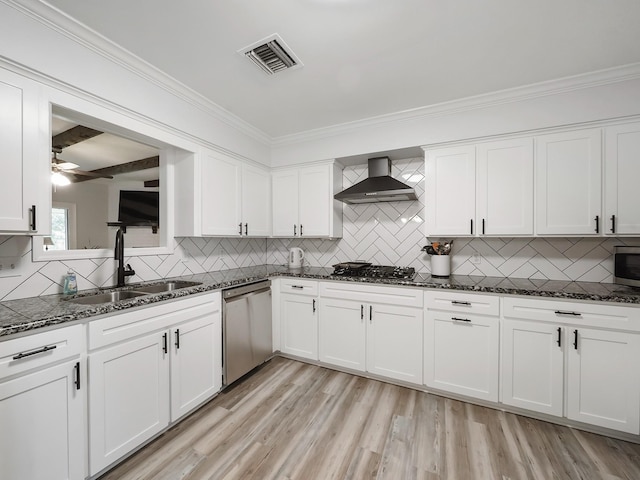 19518 Barwick Dr, Spring, TX 77373 - kitchen featuring appliances with stainless steel finishes, wall chimney range hood, backsplash, crown molding, and white cabinets