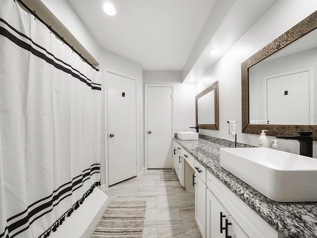 19518 Barwick Dr, Spring, TX 77373 - bathroom with double vanity, recessed lighting, marble look tile flooring, and a shower with curtain