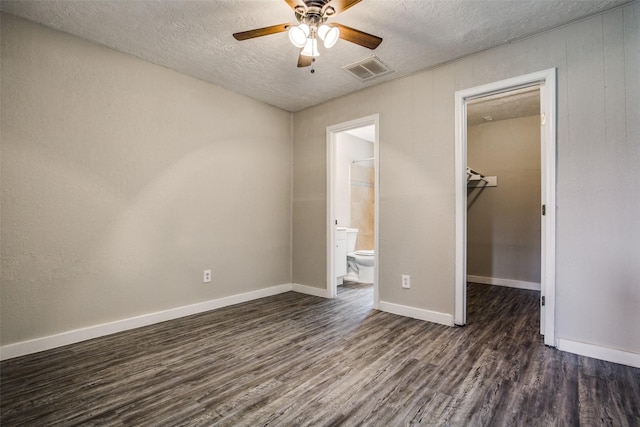 4820 Oak Ave Unit 16, Pasadena, TX 77503 - unfurnished bedroom with dark wood finished floors, a textured ceiling, a spacious closet, ensuite bath, and a closet