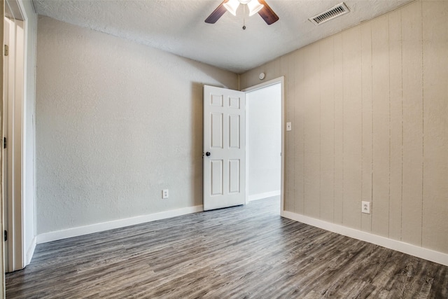 4820 Oak Ave Unit 16, Pasadena, TX 77503 - empty room featuring dark wood-style flooring, ceiling fan, a textured wall, and a textured ceiling