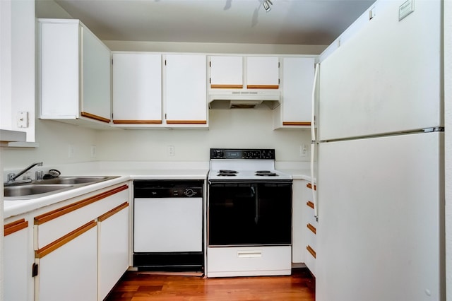 3231 Allen Pkwy Unit 1306, Houston, TX 77019 - kitchen featuring white appliances, under cabinet range hood, wood finished floors, light countertops, and white cabinetry