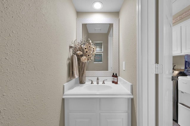 35 S Floral Leaf Cir, The Woodlands, TX 77381 - bathroom with a textured wall and vanity