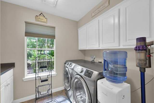 35 S Floral Leaf Cir, The Woodlands, TX 77381 - washroom featuring cabinet space, washing machine and clothes dryer, and tile patterned flooring