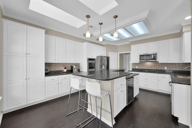 35 S Floral Leaf Cir, The Woodlands, TX 77381 - kitchen with a skylight, appliances with stainless steel finishes, backsplash, wine cooler, and a kitchen island