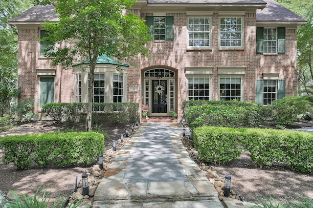 35 S Floral Leaf Cir, The Woodlands, TX 77381 - view of front of home featuring brick siding and a shingled roof