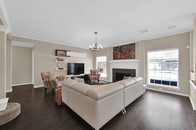 35 S Floral Leaf Cir, The Woodlands, TX 77381 - living room featuring dark wood-style flooring, a chandelier, crown molding, and a fireplace