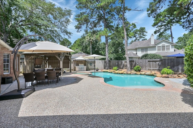 35 S Floral Leaf Cir, The Woodlands, TX 77381 - view of pool featuring a gazebo, a patio, a pool with connected hot tub, and a fenced backyard