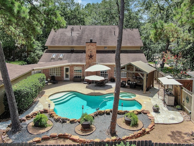 35 S Floral Leaf Cir, The Woodlands, TX 77381 - view of pool with a patio, a fenced backyard, a pool with connected hot tub, and outdoor dining space
