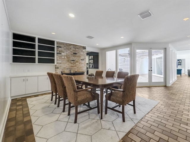 10610 Piping Rock Ln, Houston, TX 77042 - dining space featuring french doors, recessed lighting, and brick patterned floors