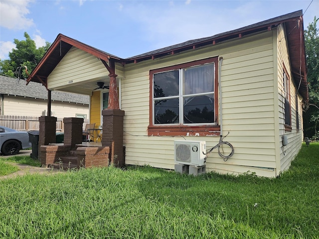 6504 Ave J, Houston, TX 77011 - view of property exterior featuring a yard, ceiling fan, and covered porch