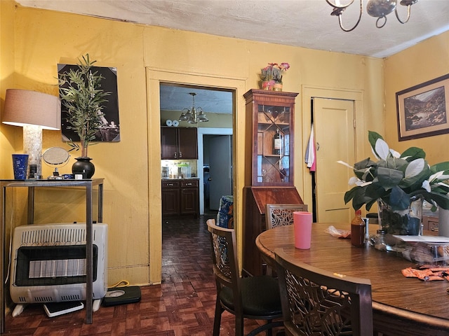 6504 Ave J, Houston, TX 77011 - dining room featuring a chandelier, heating unit, and a textured ceiling