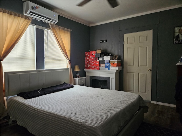 6504 Ave J, Houston, TX 77011 - bedroom with a wall mounted AC, ornamental molding, a fireplace, ceiling fan, and wood finished floors