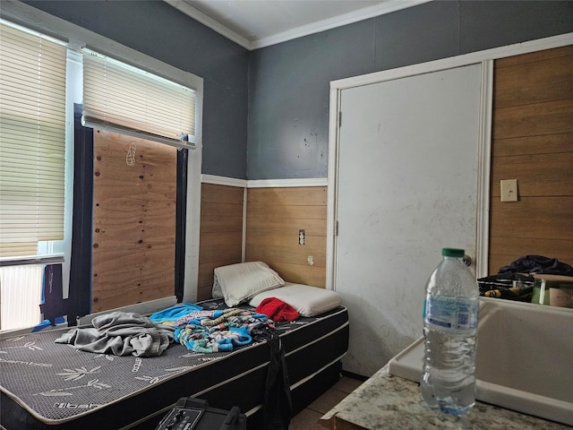 6504 Ave J, Houston, TX 77011 - bedroom with crown molding, multiple windows, and wooden walls