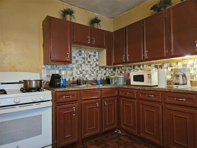 6504 Ave J, Houston, TX 77011 - kitchen featuring white appliances, decorative backsplash, and a textured ceiling