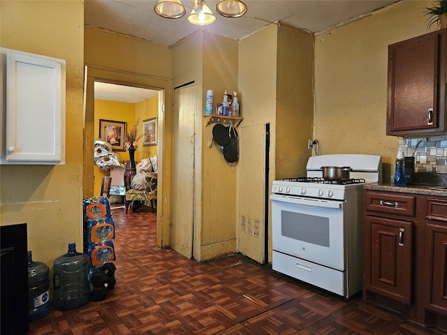 6504 Ave J, Houston, TX 77011 - kitchen with white range with gas cooktop and a chandelier