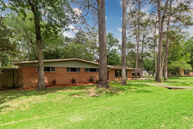 925 Royal Oak Dr, Dickinson, TX 77539 - view of front of home featuring brick siding, a chimney, and view of scattered trees