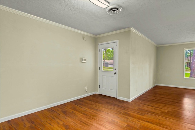 925 Royal Oak Dr, Dickinson, TX 77539 - foyer entrance with wood finished floors, a textured ceiling, and ornamental molding