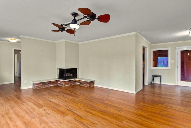 925 Royal Oak Dr, Dickinson, TX 77539 - unfurnished living room with a ceiling fan, wood finished floors, a fireplace with raised hearth, and ornamental molding