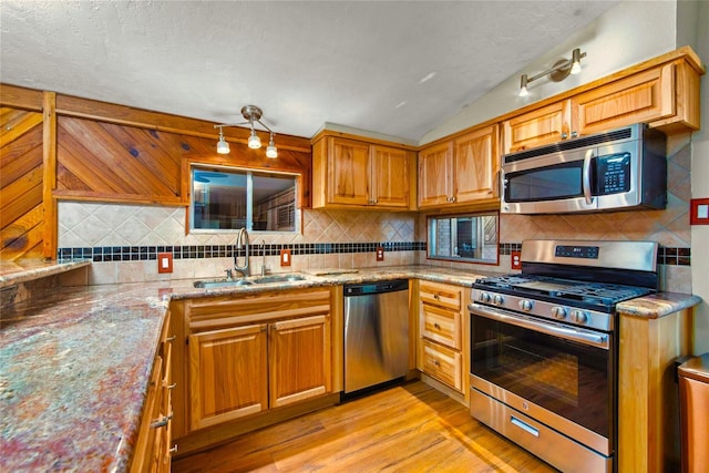 925 Royal Oak Dr, Dickinson, TX 77539 - kitchen with appliances with stainless steel finishes, light wood-style flooring, backsplash, light stone countertops, and vaulted ceiling