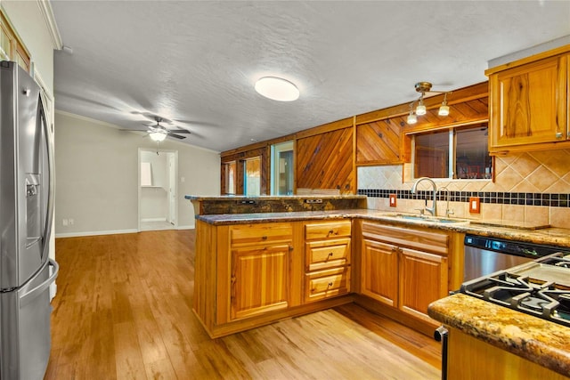 925 Royal Oak Dr, Dickinson, TX 77539 - kitchen featuring stainless steel refrigerator with ice dispenser, a peninsula, ceiling fan, backsplash, and brown cabinets