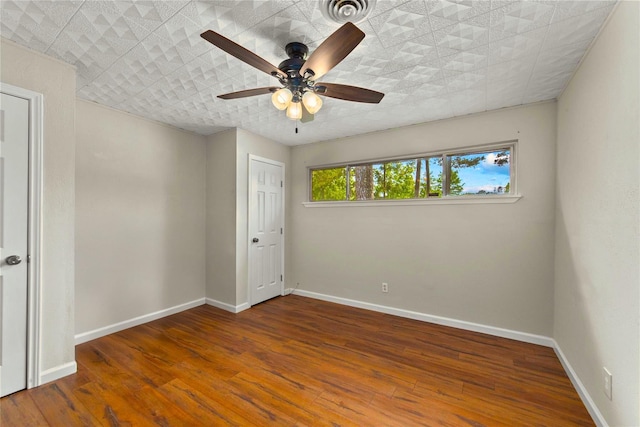 925 Royal Oak Dr, Dickinson, TX 77539 - unfurnished bedroom featuring wood finished floors and a ceiling fan