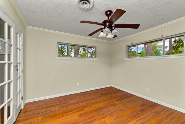 925 Royal Oak Dr, Dickinson, TX 77539 - spare room with wood finished floors, a ceiling fan, a textured ceiling, french doors, and crown molding