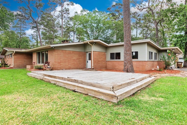925 Royal Oak Dr, Dickinson, TX 77539 - back of house with brick siding, a wooden deck, and a lawn