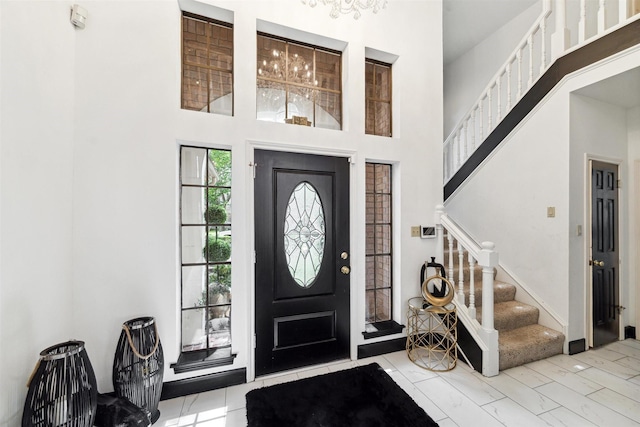 14907 Alderwick Dr, Sugar Land, TX 77498 - entrance foyer featuring a high ceiling, stairs, and marble look tile flooring