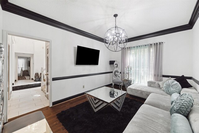 14907 Alderwick Dr, Sugar Land, TX 77498 - living area with crown molding, a chandelier, and wood finished floors
