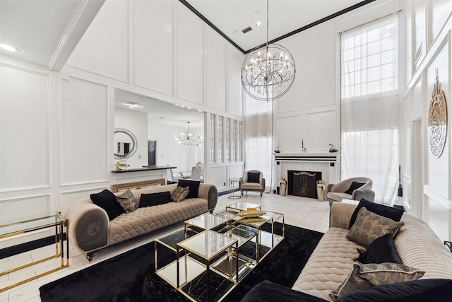 14907 Alderwick Dr, Sugar Land, TX 77498 - living room with a decorative wall, a chandelier, a towering ceiling, a tile fireplace, and crown molding