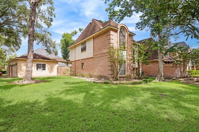 14907 Alderwick Dr, Sugar Land, TX 77498 - back of property with brick siding and an attached garage