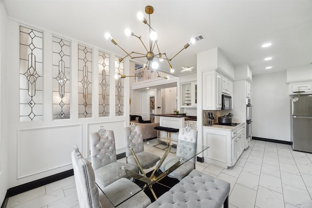 14907 Alderwick Dr, Sugar Land, TX 77498 - dining area featuring light marble finish flooring, a chandelier, and recessed lighting
