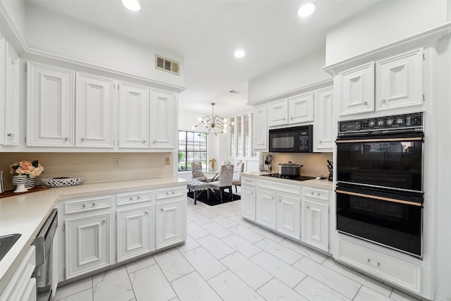 14907 Alderwick Dr, Sugar Land, TX 77498 - kitchen with black appliances, light marble finish flooring, white cabinetry, a chandelier, and light countertops