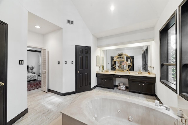 14907 Alderwick Dr, Sugar Land, TX 77498 - ensuite bathroom featuring double vanity, a jetted tub, and high vaulted ceiling
