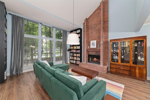3 Whistlers Walk Pl, The Woodlands, TX 77381 - living area featuring wood finished floors, a fireplace, and high vaulted ceiling