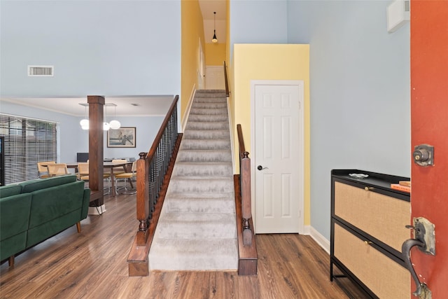 3 Whistlers Walk Pl, The Woodlands, TX 77381 - stairway with wood finished floors and crown molding