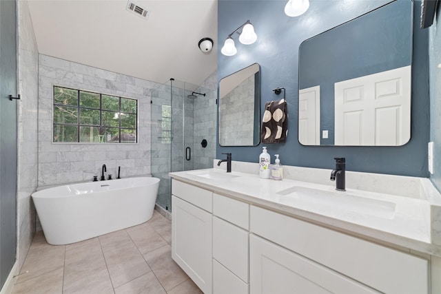 3 Whistlers Walk Pl, The Woodlands, TX 77381 - full bath with a shower stall, double vanity, a freestanding tub, tile patterned flooring, and lofted ceiling