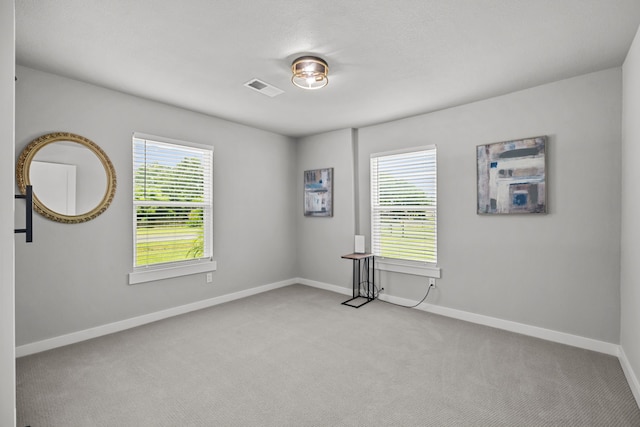 5709 David St, Dickinson, TX 77539 - carpeted empty room featuring healthy amount of natural light