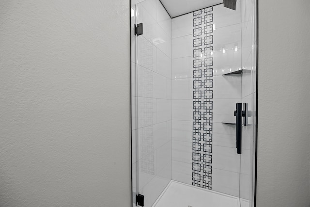 5709 David St, Dickinson, TX 77539 - bathroom with a shower stall and a textured wall