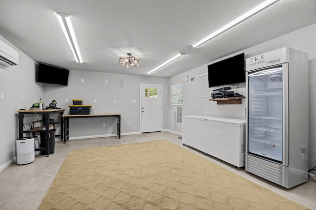 5709 David St, Dickinson, TX 77539 - kitchen with fridge, a textured ceiling, and a wall unit AC